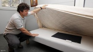 TO GO WITH AFP STORY BY REBECCA FRASQUET An engineer of the CSTB (Centre scientifique et Technique du Batiment), a research, testing, certification and training organisation working primarily in the built environment and construction, shows a smart object placed under a mattress and dedicated to Ambient Assisted Living programs, on June 18, 2015 at the French technopole of Sophia Antipolis in Valbonne, southeastern France. AFP PHOTO / JEAN-CHRISTOPHE MAGNENET (Photo credit should read JEAN-CHRISTOPHE MAGNENET/AFP/Getty Images)
