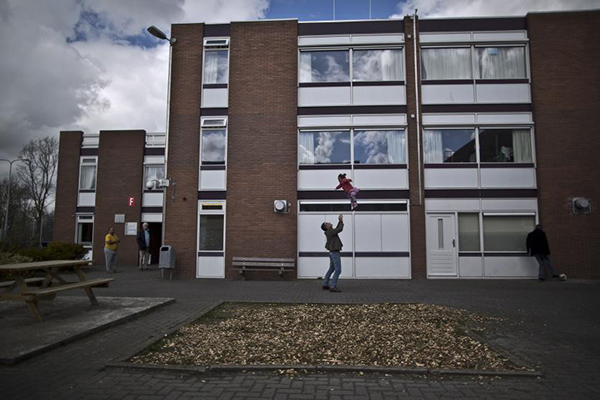 هولندا تفتح سجونها الفارغة للاجئين +صورة 2 In this Friday, April 8, 2016 photo, a migrant plays with a girl at the former prison of Westlingen in Heerhugowaard northwestern Netherlands. The Dutch government has let Belgium and Norway put prisoners in its empty cells and now, amid the huge flow of migrants into Europe, several Dutch prisons have been temporarily pressed into service as asylum seeker centers. (AP Photo/Muhammed Muheisen)
