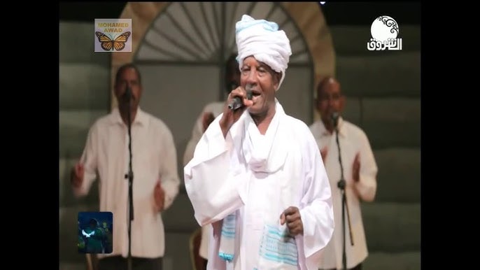 شاهد بالفيديو.. الفنان السوداني الكبير "قيقم" يحكي قصة الأغنية الشهيرة (من الأسكلا وحلا) خلال جلسة خاصة ويكشف عن الفتاة اليهودية الحسناء "إيميلن" التي بسببها كتبت الأغنية 1 قيقم